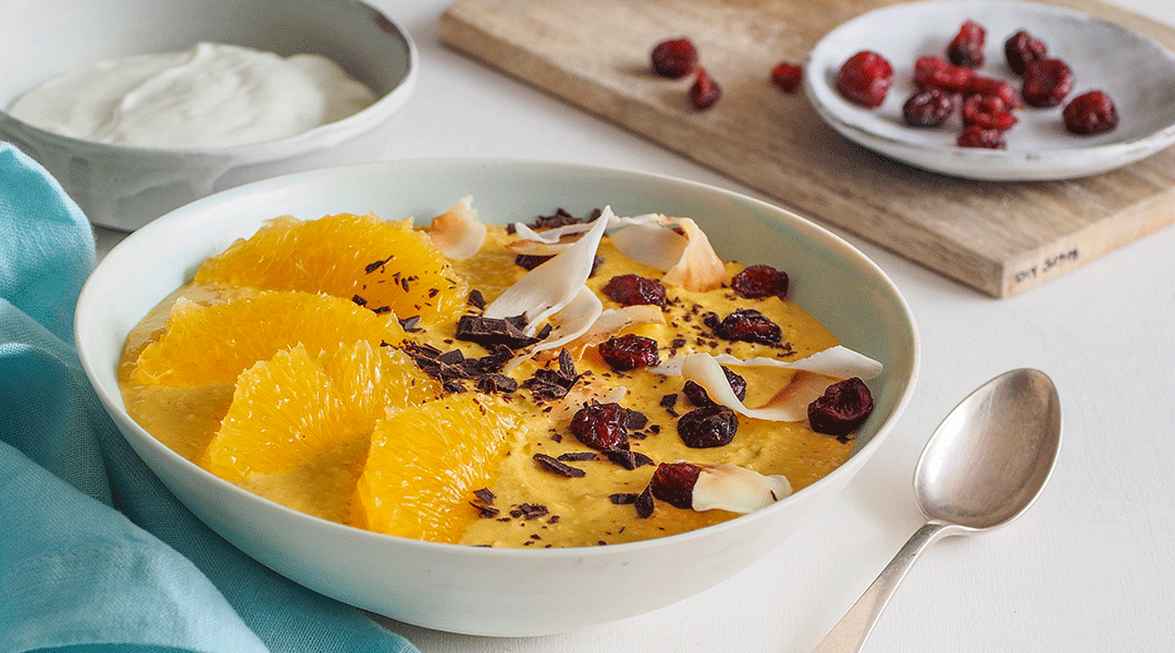 Schale mit Mango-Müsli steht neben einer Scahle mit Joghurt